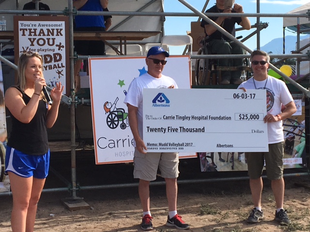 People holding large check.